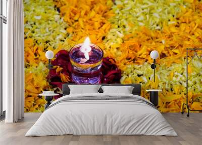 Diya flame on glass of water, flower rangoli design with diya, diwali festival of lights. Wall mural