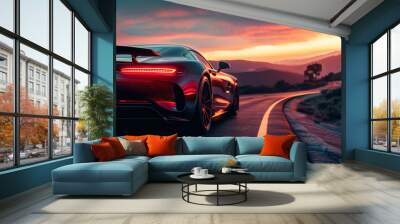 a sports car drives down a road at sunset Wall mural