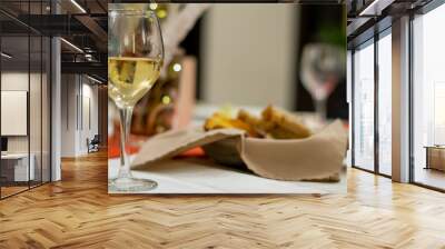 elegant table setting in background with a glass of white wine on close-up Wall mural