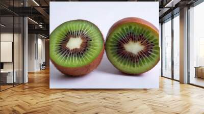 Two halves of a kiwi fruit on a white background. Wall mural