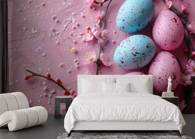 Multicolored Easter eggs with a floral pattern, resting on a pink wooden table with blossoms. Wall mural