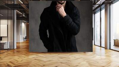 attractive young fashion model wearing black longcoat Wall mural