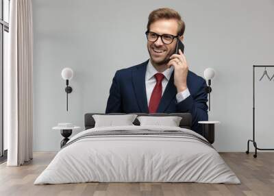 businessman talking on the phone while looking away happy Wall mural