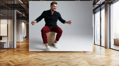 Cheerful fashion man laughing and welcoming Wall mural