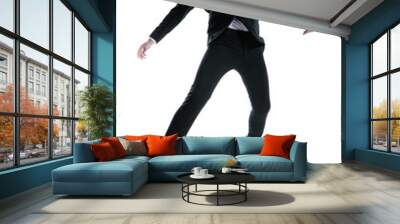 dramatic cool young man in black suit jumping in the air Wall mural