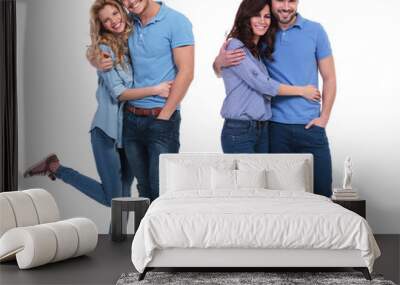 two happy couples of young casual people standing embraced Wall mural