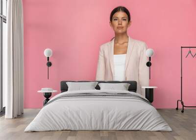 young businesswoman standing against pink background Wall mural