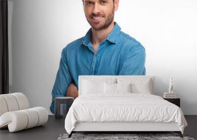 young smiling casual man standing with hands crossed Wall mural