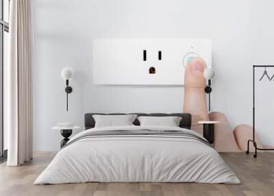 Hand pressing on-off button with blue light active for safety testing electric system on modern smart plug and wifi outlet. Minimal design of electricity with control switch for save energy on a wall. Wall mural