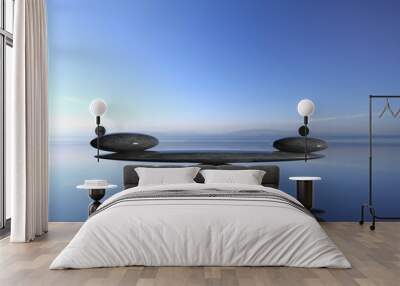 Balancing Zen stones in water with blue sky and peaceful landscape. Wall mural