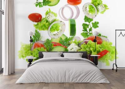 Fresh mixed vegetables falling into a bowl of salad Wall mural