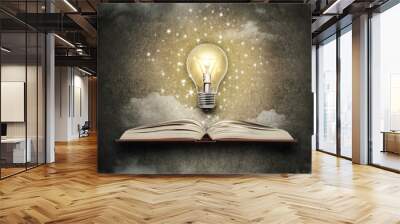 glowing bulb above a book Wall mural