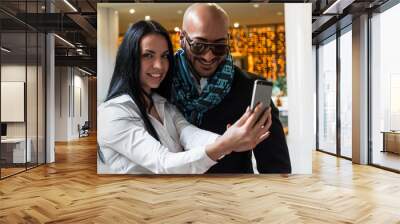 Arab businessman and girl making selfie in the shopping center Wall mural