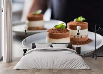 Three delicious desserts on a pristine white plate, ready to be savored Wall mural