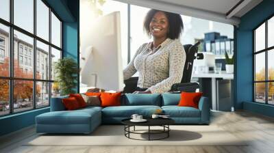 Portrait of a happy young African American woman in a wheelchair working with a computer and smiling at the camera. Digitalization and inclusion at work. Wall mural