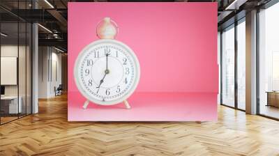 White retro alarm clock on the pink background Wall mural