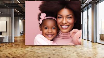 Portrait of a African American girl and mother on pink rose gold background. World Mother's Day concept Wall mural