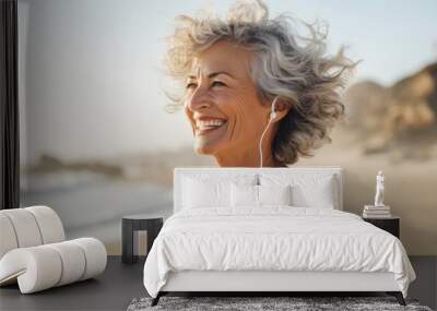 Portrait of a senior woman jogging on the beach background. Wall mural