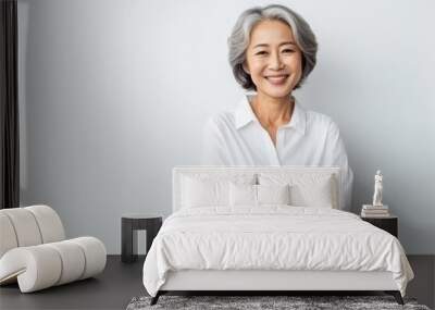 Portrait of Asian senior woman posing on white wall background. Wall mural