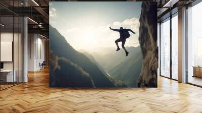 Silhouette of a person jumping and leaping on a mountain top. Wall mural