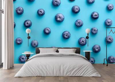 Blueberry pattern on a blue background viewed from above. Top view. Wall mural