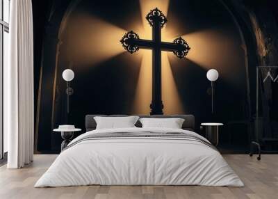 An ornate cross illuminated by a warm and golden light on a dark background Wall mural