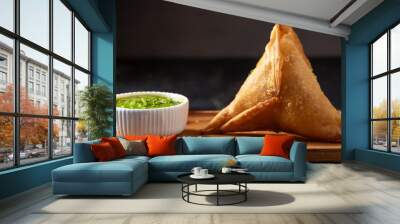 Crispy samosa with green chatni on wooden board  Wall mural