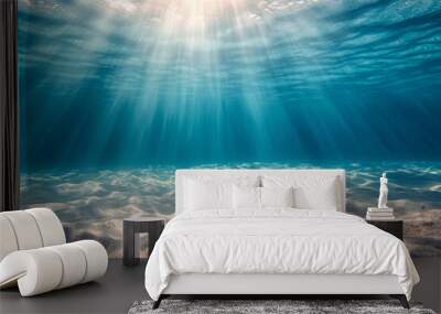 Underwater view of sandy sea bottom with sunbeams and rays Wall mural