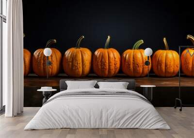 Row of Small Autumn Pumpkins with Bumpy Skin, Black Background Wall mural