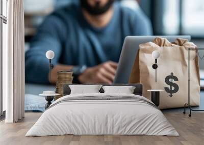 image depicts person working on laptop with stack of coins and paper bag featuring dollar sign, symbolizing financial growth and passive income opportunities Wall mural