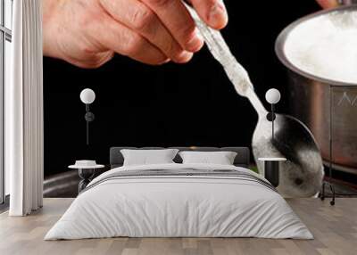 Male chef garnishing his dish, ready to serve Wall mural