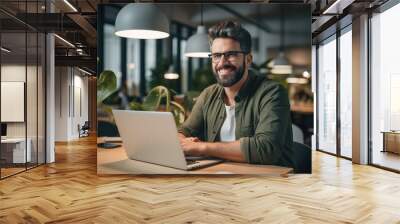 A freelancer man working in a trendy office, Working hard, Bright and happy. Wall mural