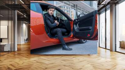 Business people getting out of his sports car. Wall mural