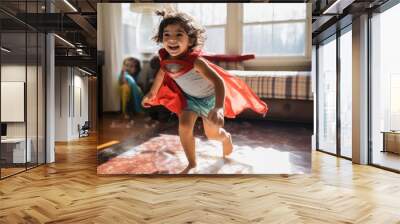 Happy child playing and runs in the room, Cute little confident girl at home in superhero costume. Wall mural