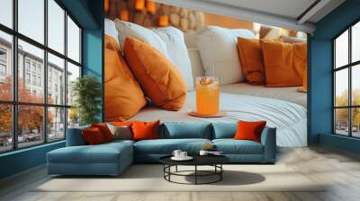 Relaxing at an event setting on a off-white cloud-like comfy couch with orange pillows while relaxing and enjoying wellness drinks. Generative AI. Wall mural