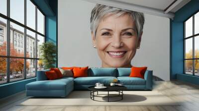 Portrait of beautiful white caucasian senior woman short pixie hair cut in front of white studio background Wall mural