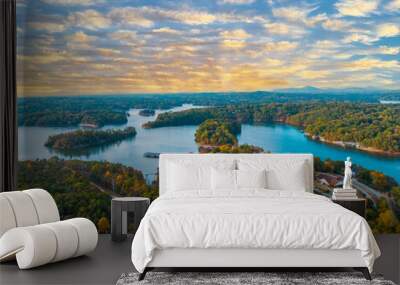 Lake Lanier in North Georgia, 4K aerial drone on a sunny fall day. Radiant clouds both blue and orange. Clear view of fall colored trees and blue lake water. Wall mural