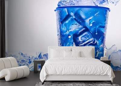 A blue cup filled with ice and ice cubes. Wall mural