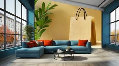 A brown paper bag sitting on top of a table next to a plant Wall mural