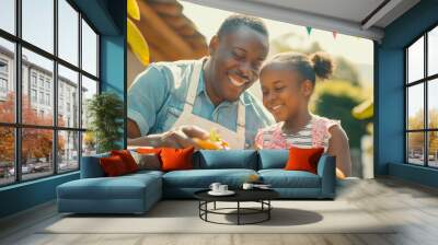 A man and a little girl grilling hamburgers outdoors. Wall mural