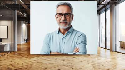 A man with glasses and a beard standing with his arms crossed Wall mural