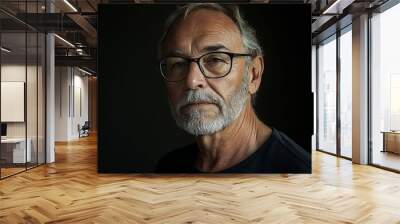 A man with glasses and a white beard wearing a black shirt Wall mural