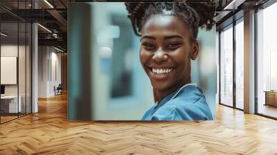 A smiling nurse in scrubs. Wall mural