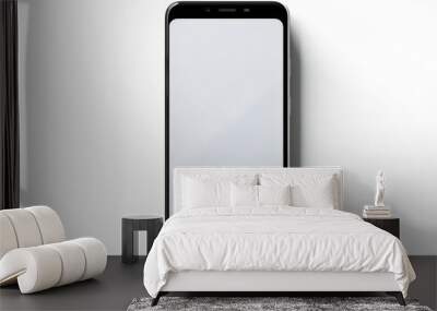 Black cell phone with white screen on white surface. Wall mural