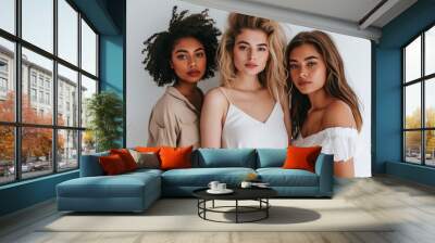 Three beautiful women posing for a photo. Wall mural