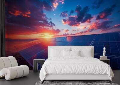 A beautiful sunset over photovoltaic panels with a bright orange sun in the sky Wall mural