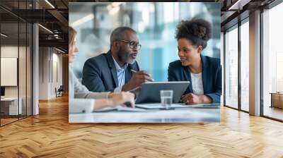 Team of partners discussing project sitting at table in office Wall mural