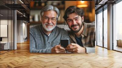 Smiling mature grey-haired 60s father and grownup son relax on sofa at home browse smartphone together. Happy older Caucasian dad and adult man child have fun use cellphone talk on call, Generative AI Wall mural