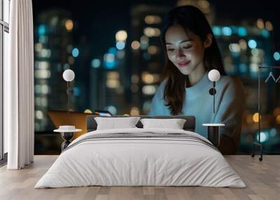 Young happy busy Asian business woman executive using laptop mobile cell phone tech at night in dark office. Professional businesswoman holding smartphone, working on, Generative AI Wall mural