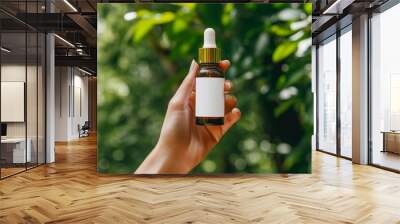 a female hand modeling a serum bottle with blank white label, mockup, product shoot, close up shot, outdoor background Wall mural